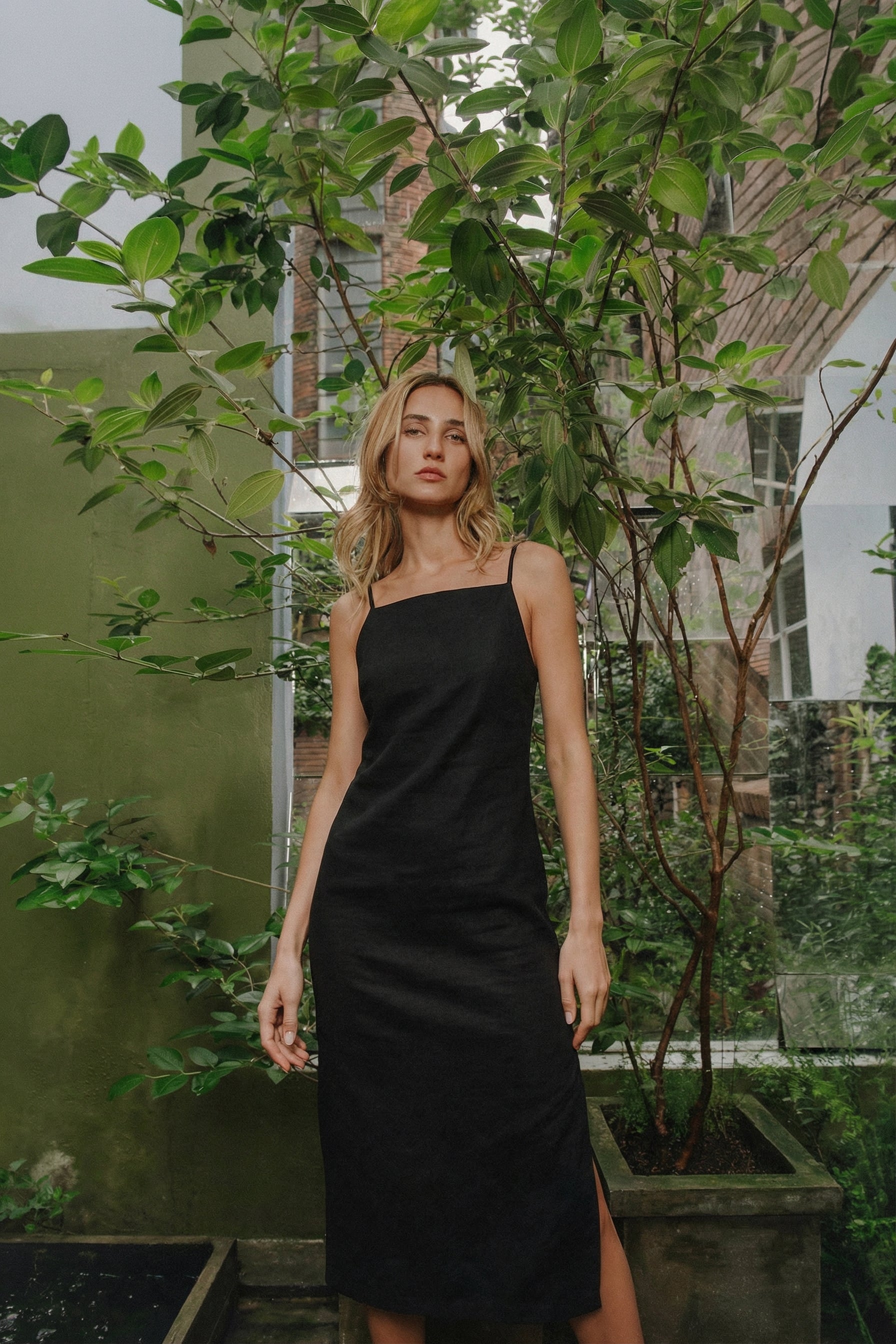 Model wearing black slip dress