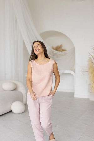 Model smiling in dusty rose linen pants and a matching top, capturing the relaxed and airy feel of the lightweight linen ensemble.