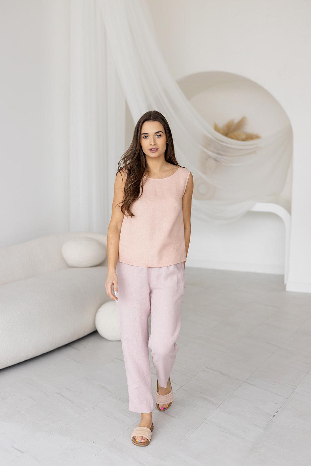 Ash pink linen tank top on model, sleeveless, scoop neck, relaxed fit.