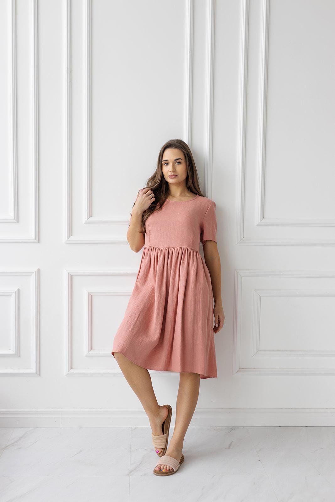 Front View of Dress: A full view of the linen midi dress, featuring a timeless silhouette, a comfortable fit, and a neutral blush salmon tone.