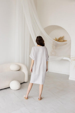 Back view of a mid-length linen dress with a straight-cut fit, relaxed drape, and minimalist design. Soft, airy, and comfortable for warm-weather wear.