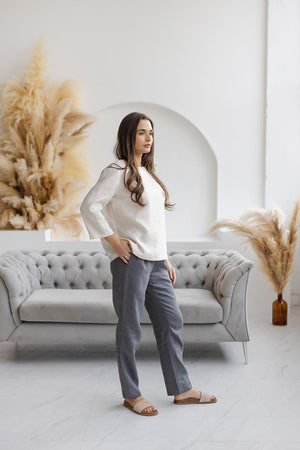 Side view of off-white linen blouse, relaxed boxy fit, 3/4 sleeves.