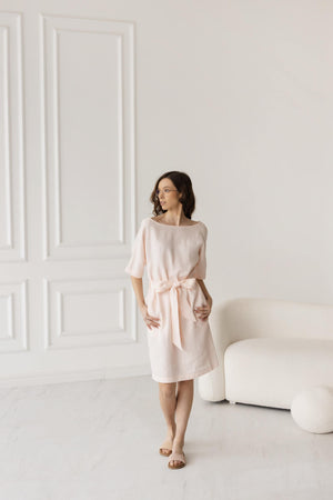 Knee-length petal pink tie-waist dress, relaxed fit, casual beachwear.