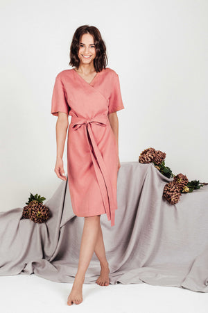 Flattering blush linen midi wrap dress by SonFre, featuring a V-neckline, short sleeves, adjustable tie belt, and a classic wrap design, perfect for summer style.