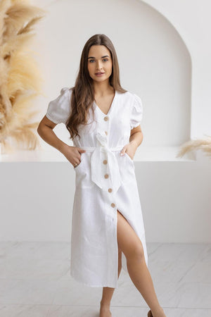 White linen button-down dress with puff sleeves, A-line silhouette, and natural wooden buttons, ideal for summer fashion.