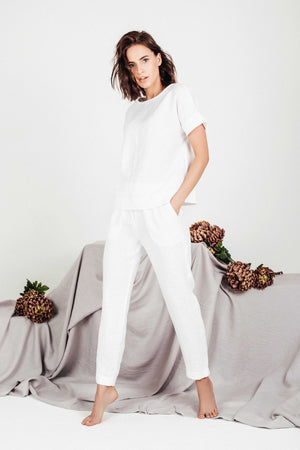 Profile view showcasing relaxed short-sleeve design of the SORA white linen blouse