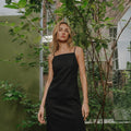 Model wearing black slip dress