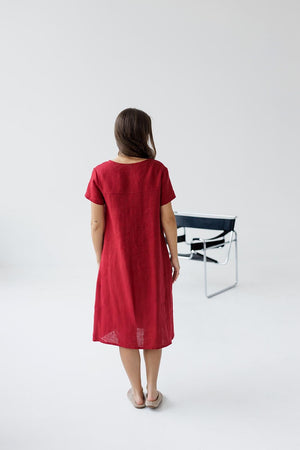 Back view of the burgundy red linen maternity dress, highlighting the lightweight fabric and comfortable design.