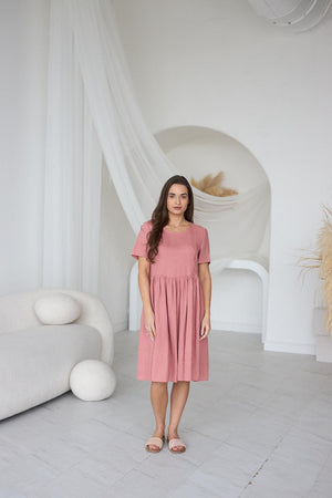 Close-up of blush salmon linen fabric; lightweight texture, soft drape, and fabric movement.