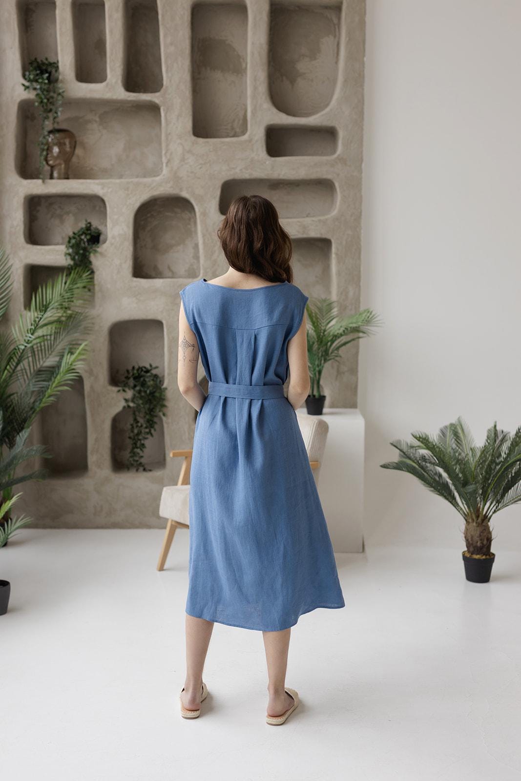 Linen midi dress, structured back yoke, adjustable belt.