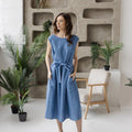 Linen midi dress, sleeveless, belted waist, minimalist design.