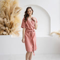 Elegant blush salmon linen wrap dress for women, featuring a belted waist, short sleeves, and a V-neckline. A handmade, breathable linen midi dress ideal for summer and casual occasions.