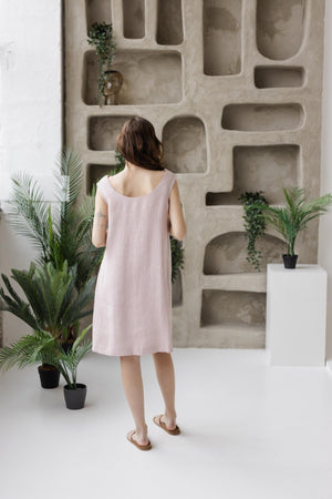 Dusty rose linen shift dress, scoop back view, relaxed fit, modern decor.