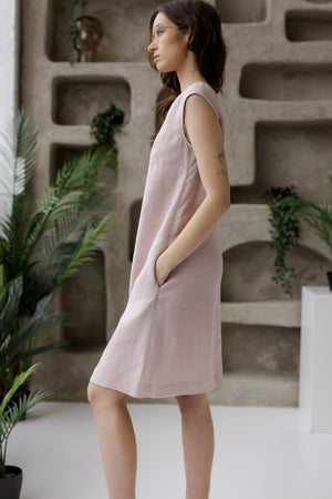 Sleeveless linen shift dress with pockets, dusty rose, minimalist background.