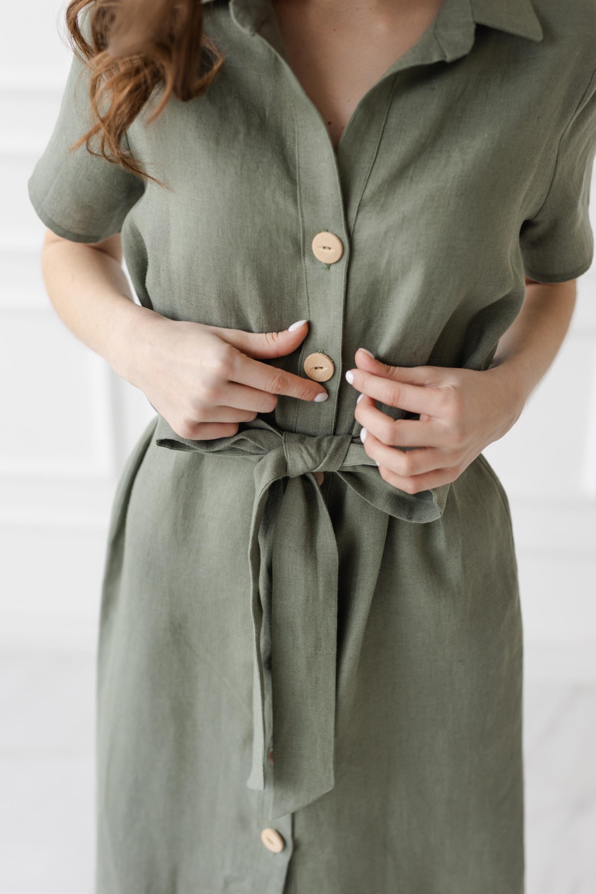 Lightweight linen dress in eucalyptus color, knee-length button-up design with a tie belt, perfect for casual summer style