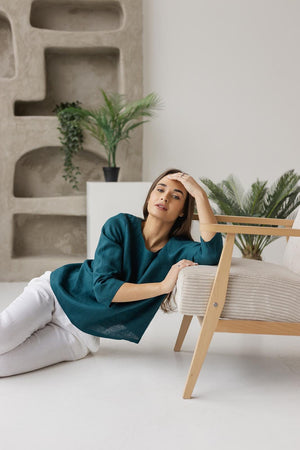 Soft and breathable 100% linen fabric close-up, highlighting the natural texture of the teal green women's blouse.