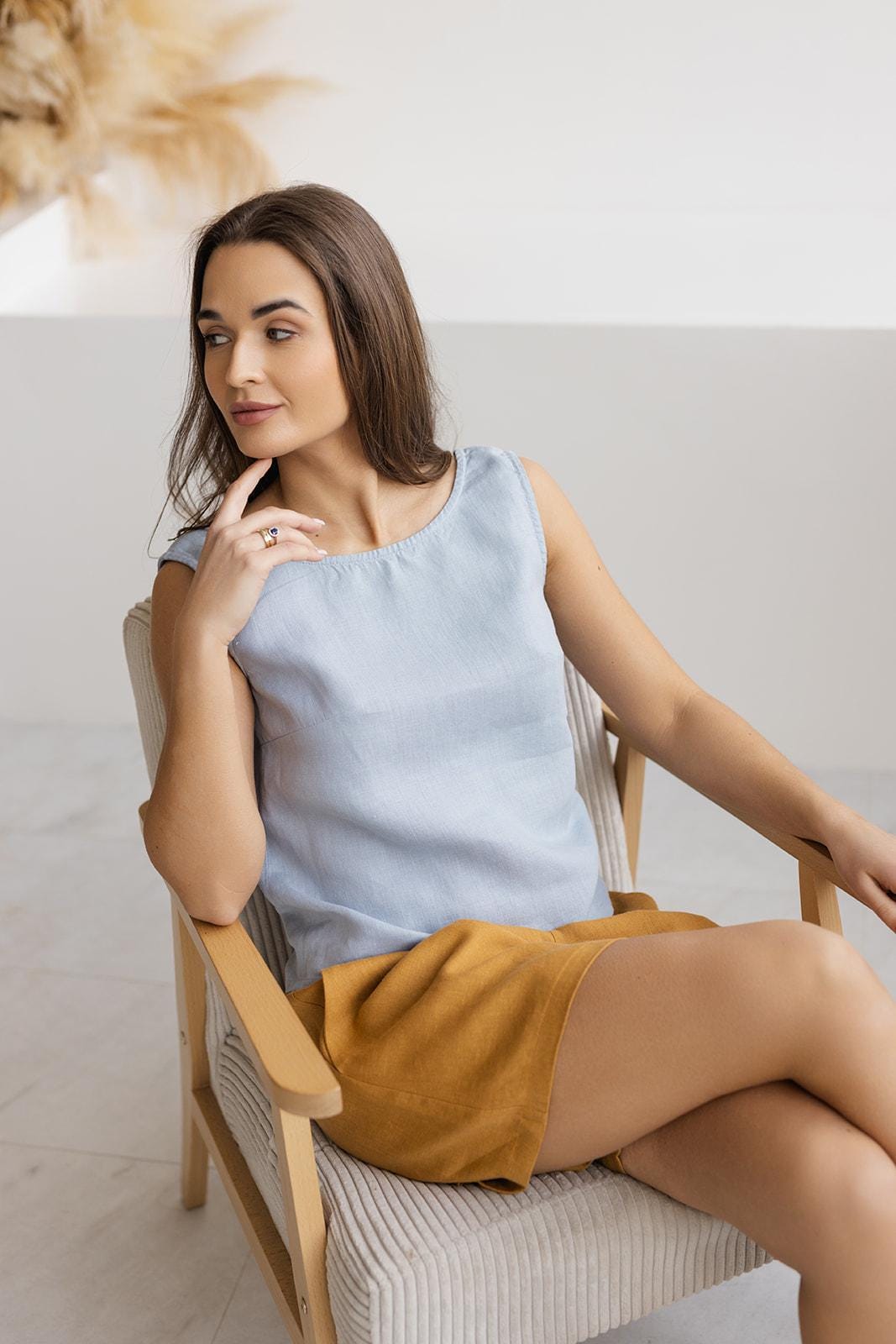 Close-up of mustard linen shorts fabric, emphasizing breathable and soft linen texture for all-day comfort.