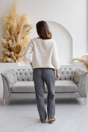 Back view: off-white linen blouse, boxy fit, natural linen texture.