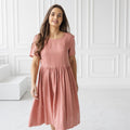 Blush salmon linen midi dress in motion; breathable fabric, airy fit, summer dress.