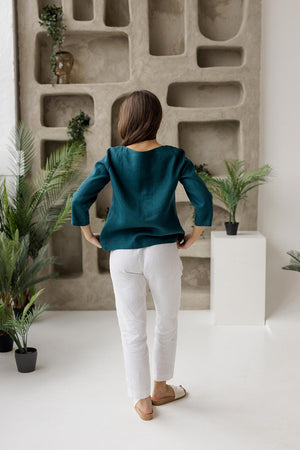 Back view, teal green linen blouse, relaxed fit, minimalist design, mid sleeves, boat neck.
