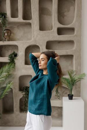 Side view, linen boat neck blouse, mid sleeves, loose fit, teal green women`s summer top.