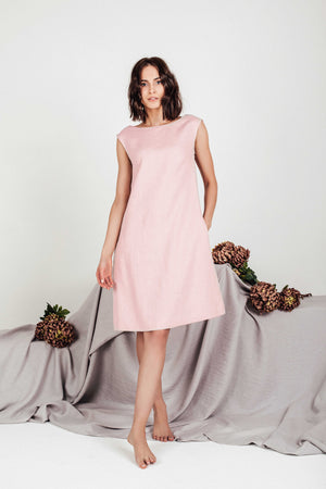 Model wearing the SonFre VELA sleeveless linen shift dress in dusty rose, featuring a relaxed knee-length silhouette and functional side pockets.