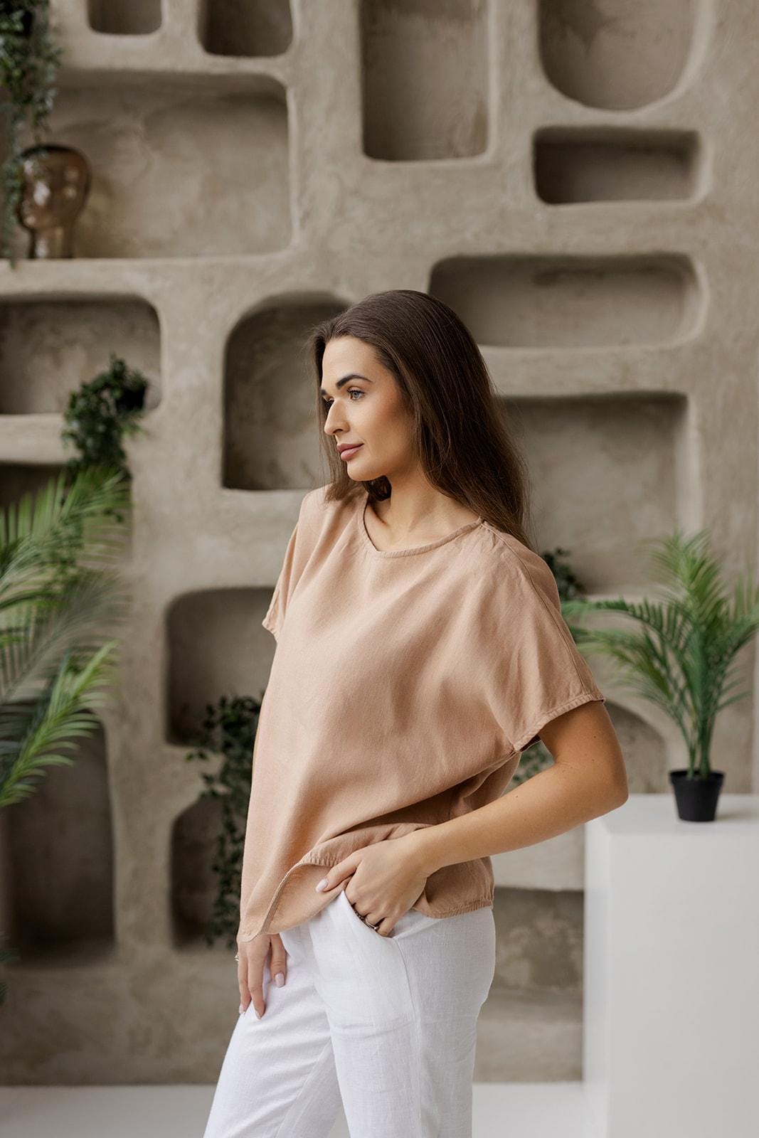 Side view of a taupe linen blouse for women, featuring a loose-fit silhouette and short sleeves. Made from breathable, high-quality linen for ultimate comfort and effortless style. Ideal for minimalist and sustainable fashion.