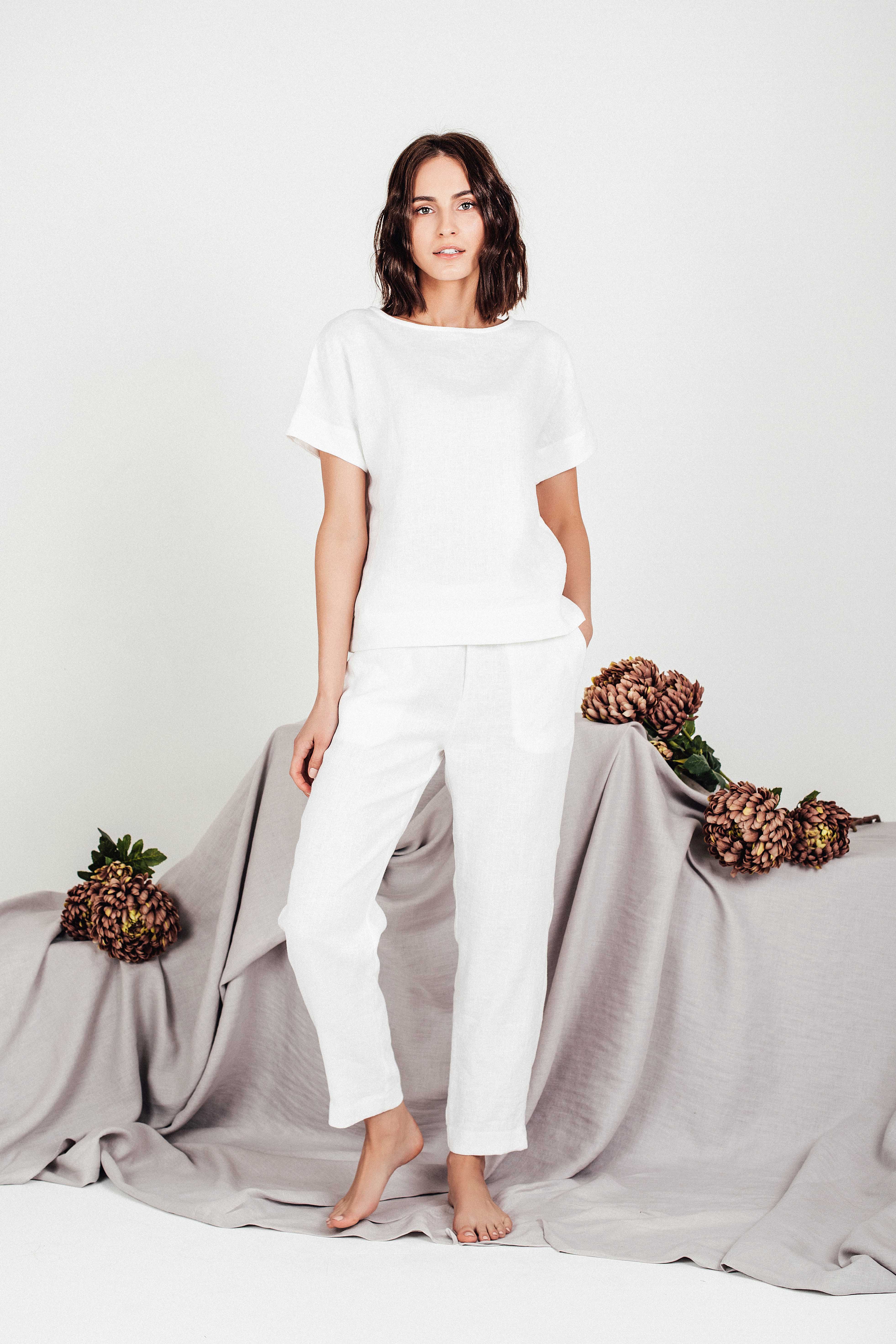 Full-body view of woman wearing matching white linen set, featuring boxy linen top and pants
